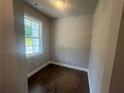 Bright room featuring hardwood floors, a window, and neutral paint, perfect for office or flex space at 315 Lakeside Ct, Canton, GA 30114