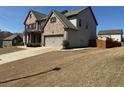 Spacious home with attached two-car garage and a long driveway leading to the backyard at 5530 Lacebark Pine Ct, Cumming, GA 30040