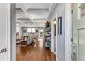 Open-concept living room featuring hardwood floors, coffered ceilings, and abundant natural light at 1324 Cambridge Ave. Sw, Atlanta, GA 30344