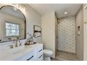 Modern bathroom boasts a glass-enclosed shower with beautiful tile and a stylish vanity at 1450 Cedarhurst Dr, Dunwoody, GA 30338