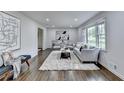 Sunlit living room with hardwood floors, plush rug, and elegant decor at 1450 Cedarhurst Dr, Dunwoody, GA 30338