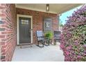 Inviting front porch showcasing brick detail and black rocking chairs at 5111 Olive Branch Cir, Powder Springs, GA 30127