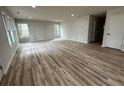 Spacious living room with wood-look flooring, abundant natural light, and fresh paint at 517 Whitley Dr, Forest Park, GA 30297