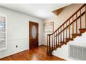 Inviting foyer showcasing wood flooring, staircase, and a decorative front door at 300 Smith Ave, Bowdon, GA 30108