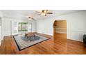 Spacious living room featuring hardwood floors, ceiling fans, and an open layout at 300 Smith Ave, Bowdon, GA 30108