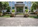 Condo exterior entrance with flower planters, benches, and 'The Paramount' signage at 3445 Stratford Ne Rd # 608, Atlanta, GA 30326