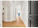 Bright hallway with wood floors, built-in shelves, and an interior blue door at 3445 Stratford Ne Rd # 608, Atlanta, GA 30326