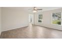 Bright living room featuring wood-look flooring, two windows, and neutral walls, offering a versatile and comfortable space at 164 Edison Dr, Stockbridge, GA 30281