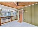 Charming covered front porch with stained ceiling and modern ceiling fan at 2243 Newnan St, Atlanta, GA 30344