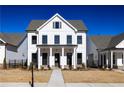 A charming two-story home with a white exterior, black trim, and inviting front porch at 532 Pearl St, Cumming, GA 30040