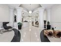 Elegant lobby area with sleek terrazzo flooring, decorative columns, and modern furniture at 860 Peachtree Ne St # 2212, Atlanta, GA 30308