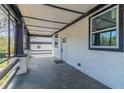 View of the covered front porch with gray tile flooring, white railings, and view of neighboring home at 1831 Jonesboro Se Rd, Atlanta, GA 30315