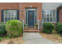 Close-up of the home's front door, showcasing a decorative glass insert and sidelights at 5280 Oak Hill Ter, Cumming, GA 30040