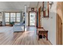 Bright foyer featuring wood floors, a wooden bench, and views into the living room with large windows at 730 Ponderosa Ct, Fayetteville, GA 30214