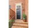 Elegant brick home featuring a stately front door with decorative trim and manicured landscaping at 105 Jefferson Cir, Sandy Springs, GA 30328