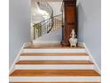 Beautiful staircase with hardwood steps, white risers, and a curved wrought iron railing at 105 Jefferson Cir, Sandy Springs, GA 30328