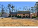 Well-kept home with an attached garage, lush bushes, and a spacious front yard at 35 Tracechain, Stockbridge, GA 30281