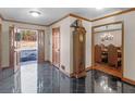 Inviting foyer with glossy tiled flooring, decorative wood trim, and chandelier lit dining room at 35 Tracechain, Stockbridge, GA 30281