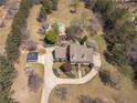 Aerial view of the home showcasing its beautifully landscaped yard and surrounding wooded acreage at 8906 E Carroll Rd, Winston, GA 30187