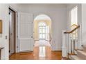 Grand foyer with hardwood floors, staircase, arched doorway, and access to an elevator at 1209 The By Ne Way, Atlanta, GA 30306