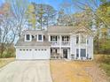 Charming two-story home featuring a two-car garage, inviting balcony, and manicured front yard at 2560 Ashley Downs Ln, South Fulton, GA 30349