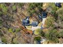 Aerial view of a secluded home with lush landscaping, a garage, and a private driveway at 1064 Brooks Rackley Rd, Dallas, GA 30157