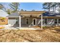 Spacious backyard with a covered patio and ceiling fan, perfect for relaxing and entertaining at 5328 Monticello Dr, Villa Rica, GA 30180