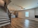 Spacious living area with a sleek fireplace, hardwood floors, and lots of natural light at 6420 Olmadison Pl, Atlanta, GA 30349