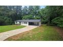 Elevated view of ranch style home with an attached carport and mature trees at 663 Embry Ln, Marietta, GA 30066