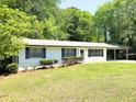 Inviting single-story home with updated white brick exterior and landscaped front yard at 663 Embry Ln, Marietta, GA 30066