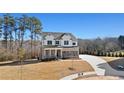 Charming two-story home with manicured lawn, paved driveway, stone and siding exterior, and attached garage at 3816 Havenrock Drive, Marietta, GA 30066