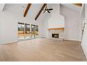Spacious living room featuring vaulted ceilings, hardwood floors, large sliding doors, and a brick fireplace at 3819 Havenrock Dr, Marietta, GA 30066