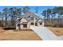 Beautiful two-story home with a modern brick facade and long concrete driveway at 3820 Havenrock Dr, Marietta, GA 30066