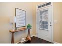 Inviting entryway featuring stylish decor and a message art, next to the door to the outside at 5965 Ellington Cv, Cumming, GA 30040