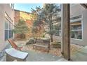 Cozy brick walled courtyard with small trees, gravel, bench, and stone seating area at 350 Peters Sw St # 19, Atlanta, GA 30313