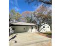 Well-maintained home featuring a large carport and freshly painted white brick at 4651 S Roberts Drive, Sugar Hill, GA 30518