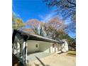 Lovely single-story home with a long carport and inviting curb appeal at 4651 S Roberts Drive, Sugar Hill, GA 30518