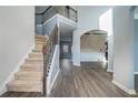 The foyer boasts soaring ceilings, hardwood floors, and an elegant staircase at 508 Arbor Trl, Loganville, GA 30052