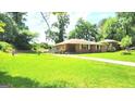 Inviting home with a spacious front yard and classic brick exterior in a serene setting at 2213 Sharon Way, Decatur, GA 30032