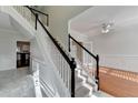 Welcoming entryway with staircase featuring black handrails, carpeted steps, and open access to the formal living room at 1824 Kristen Ct, Suwanee, GA 30024