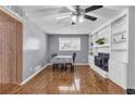 Inviting dining room with hardwood floors, a brick fireplace, and built-in shelving at 4444 Casco Nw Ln, Lilburn, GA 30047