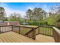 Spacious backyard view from deck showcasing a large yard and pool area with a blue umbrella at 2520 Robin Hood Ne Pl, Marietta, GA 30068
