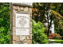 Stone monument indicating entrance to historic Brookhaven, established in 1910, surrounded by lush greenery at 978 Moores Club Ne, Atlanta, GA 30319