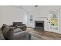 Bright living room with new flooring, a fireplace, and a door to the outdoors at 300 Lakeside Dr, Covington, GA 30016