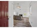 Inviting living room featuring hardwood floors, a ceiling fan, and a cozy fireplace at 300 Lakeside Dr, Covington, GA 30016