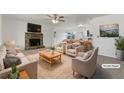 Bright, staged living room features a stone fireplace, neutral decor, and seamless flow to the kitchen at 31 Fox Creek Ct, Dallas, GA 30157