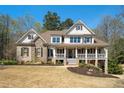 Inviting two-story home boasting a classic design, a welcoming front porch, and lush landscaping at 3227 Aviary Nw Ct, Acworth, GA 30101