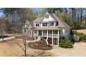Stately two-story home with a charming front porch nestled among mature trees at 3227 Aviary Nw Ct, Acworth, GA 30101