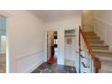 Welcoming foyer with stone flooring, staircase, and access to various rooms at 993 Castle Falls Dr. Ne Dr, Atlanta, GA 30329