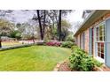 Well-maintained front yard with green lawn, colorful flowerbeds, and lush landscaping at 993 Castle Falls Dr. Ne Dr, Atlanta, GA 30329